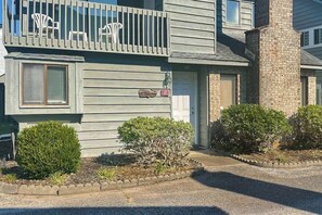 A two-story building with a balcony, a mailbox, and a small garden area. - Willow Winds Unit 17 (North Myrtle Beach)