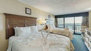 A hotel room with two beds, a balcony, and a view of the ocean. - Compass Cove Unit 560 (Myrtle Beach)