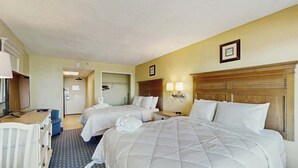 A hotel room with two beds, a desk, a chair, and a wardrobe. - Compass Cove Unit 560 (Myrtle Beach)