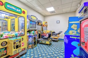 A room with arcade games, including a yellow 'PUSH BUS' game, a 'Pac-Man' machine, and a 'Tokaido' game. - Compass Cove Unit 560 (Myrtle Beach)