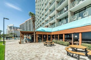 A hotel with outdoor seating, a covered patio, and a pool area. - Sand Dunes Resort 2647/2648 (Myrtle Beach)