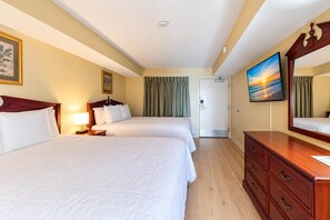 A hotel room with two beds, a wooden dresser, a television, and a door leading to another room. - Oceanfront Luxe | Atlantica Seven Fifty-Five (Myrtle Beach)