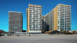 A modern high-rise building with multiple balconies, a flat rooftop, and a clear sky. - Sands Ocean Club 1629/1630 (Myrtle Beach)