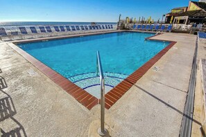 A swimming pool with a clear blue water, surrounded by blue and white sun loungers, and a view of the ocean. - Sands Ocean Club 1629/1630 (Myrtle Beach)