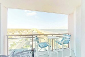 A balcony with a view of a beach and cityscape. - Bahama Sands Unit 1201 (North Myrtle Beach)