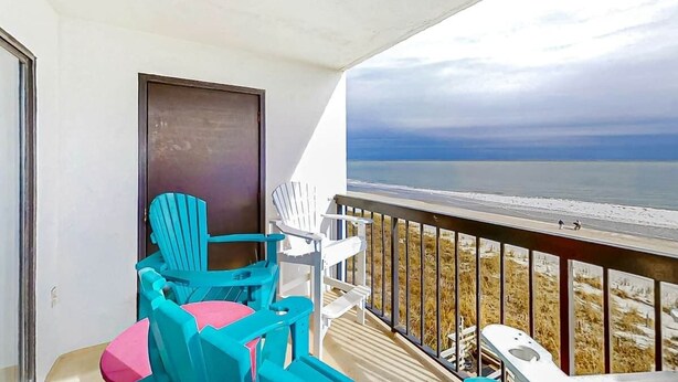 A balcony with a view of the beach, a door, and two chairs. - Crescent Towers I - 304 (North Myrtle Beach)