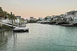 A waterfront property with a dock, multiple houses, and a calm water body. - Casa del Mare Beach House (North Myrtle Beach)