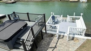A dock with a covered seating area and a boat ramp. - Casa del Mare Beach House (North Myrtle Beach)
