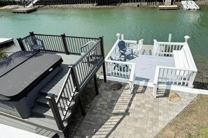A dock with a covered seating area and a boat ramp. - Casa del Mare Beach House (North Myrtle Beach)