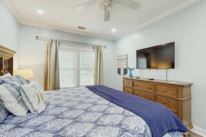 A bedroom with a bed, a dresser, a television, and a ceiling fan. - Hello Sunshine Beach House (North Myrtle Beach)