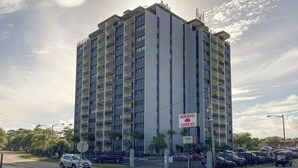 A multi-story hotel with a sign indicating 'Holiday Towers.' - Holiday Towers Unit 501 (Myrtle Beach)