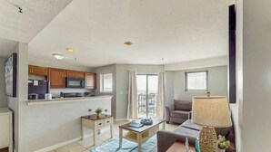 A compact living space with a kitchenette, a dining area, and a seating area with a view. - Beyond the Blue Retreat (Myrtle Beach)
