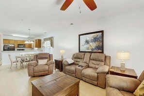 A modern living room with a sofa set, a coffee table, and a painting on the wall. - Willowbend Unit 1511 (North Myrtle Beach)