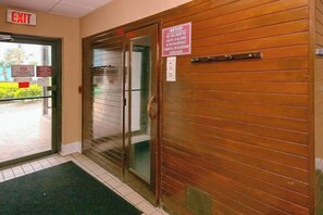 An exit door with a sign indicating no one under 18 allowed without supervision. - Palace Resort Unit 706 (Myrtle Beach)