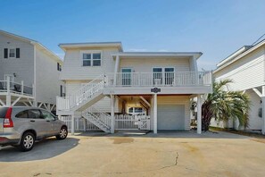 A two-story building with a covered front entrance and a staircase leading to the upper level. - Ward's Landing Retreat (North Myrtle Beach)