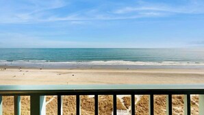 A beach view from a balcony with a railing, sandy beach, and ocean. - Verandas Unit 803 Condo (North Myrtle Beach)