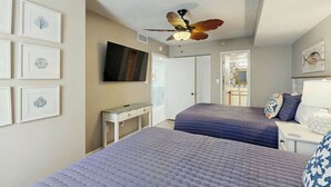 A hotel room with two beds, a ceiling fan, a flat-screen TV, and framed artwork on the walls. - Verandas Unit 803 Condo (North Myrtle Beach)