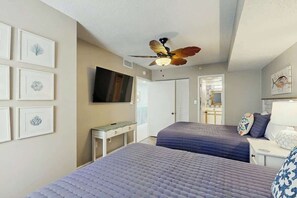 A hotel room with two beds, a ceiling fan, a flat-screen TV, and framed artwork on the walls. - Verandas Unit 803 Condo (North Myrtle Beach)