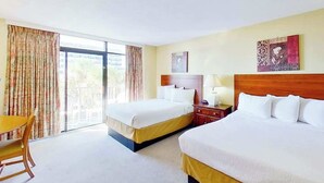 A hotel room with two beds, a desk, and a chair. - Ocean Park Resort 0322/0324 Combo (Myrtle Beach)
