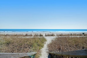 A beach path leading to the ocean with a wooden fence on one side. - Ocean Park Resort 0922/0924 Combo (Myrtle Beach)