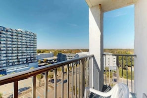 A balcony with a view of a parking lot and buildings. - Ocean Park Resort 0922/0924 Combo (Myrtle Beach)