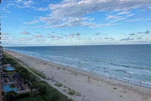 A beach with a pool area and a view of the ocean. - Pelicans Flight at Sandcastle South (Myrtle Beach)
