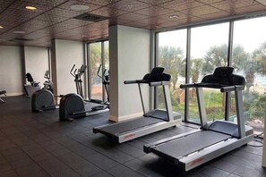 A gym with treadmills, ellipticals, and weight machines. - Sandcastle South 1509 (Myrtle Beach)