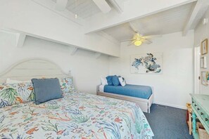 A bedroom with a bed, a smaller bed, a ceiling fan, and a wall-mounted artwork. - Lakefront Retreat at Litchfield by the Sea (Pawleys Island)