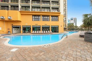 A swimming pool with a clear blue water surface, surrounded by a brick patio. - The Patricia Grand 1804 (Myrtle Beach)