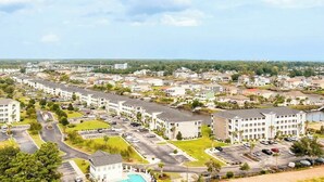 A residential area with multiple apartment buildings, roads, and greenery. - Carolina Yacht Landing E-13 (Little River)