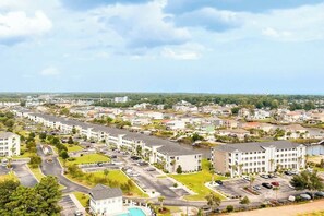 A residential area with multiple apartment buildings, roads, and greenery. - Carolina Yacht Landing E-13 (Little River)
