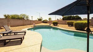 A swimming pool with lounge chairs and a pergola. - Elevated Beautiful Home Heated Pool Dog Friendly (Scottsdale)