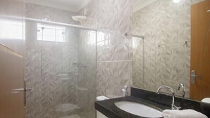 A bathroom with a glass shower enclosure, a sink with a marble countertop, and a mirror. - House w/ 2 Suites in a Cond. w/ Pool Blv0004 (Porto Seguro)