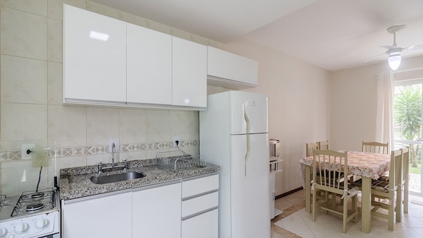 A kitchen with white cabinets, a granite countertop, a built-in stove, and a refrigerator. - 2BR House w/ BBQ 150m From Beach Ccm0008 (Bombinhas)