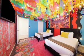 A room with two beds, a colorful ceiling, and a vibrant wall mural. - Luxury 7-BD Villa - Pool, Theater, and Game Room (Davenport)