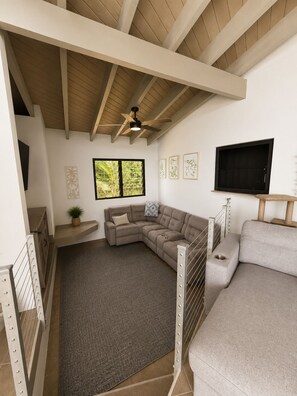 A spacious living area with a large sectional sofa, a ceiling fan, and a view of greenery outside. - Caribbean Hillside Retreat Ocean Views Minutes to Hull Bay & Magens Bay (St Thomas)