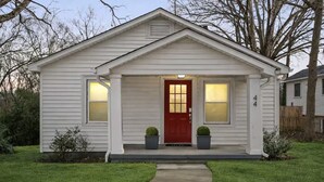 A single-story house with a red front door, two potted plants on either side, and a number '44' on the right side of the door. - Entire home in Concord, North Carolina, United States (Concord)