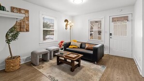 A living room with a sofa, coffee table, and a potted plant. - Entire home in Concord, North Carolina, United States (Concord)