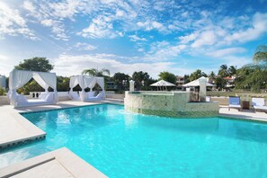 A clear blue pool with white canopies and lounge chairs. - Private 4BR Villa with Pool inside All-Inclusive Beach Resort, Puerto Plata (Puerto Plata)