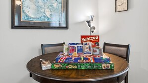 A dining table with board games and a framed map on the wall. - 3 bdrm, 7 Minutes from downtown (Kansas City)