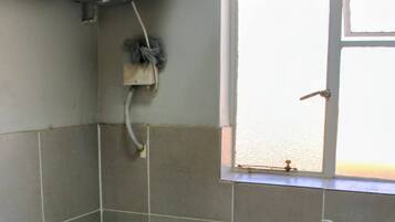 Un baño con bañera, lavamanos, inodoro y ventana.