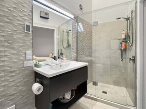 Secador de cabelo, toalhas de banho, shampoo, papel higiênico