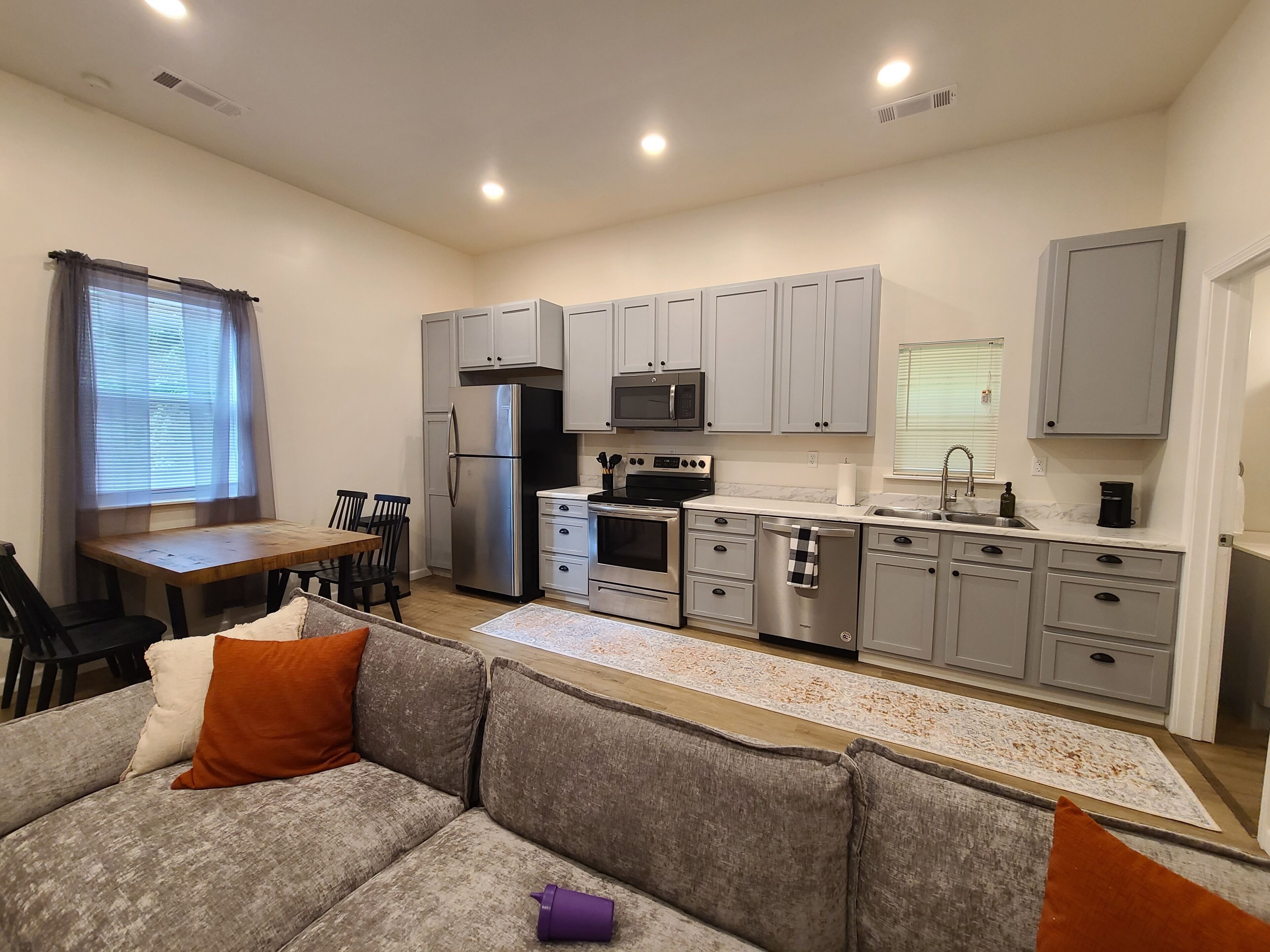 A compact living space with a kitchenette, dining area, and seating area.