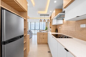 Stylish kitchen with modern cabinetry, microwave, cooktop, and everything needed for preparing meals during your stay. - Remodeled Isla Verde Condo • One block to Beach (Carolina)