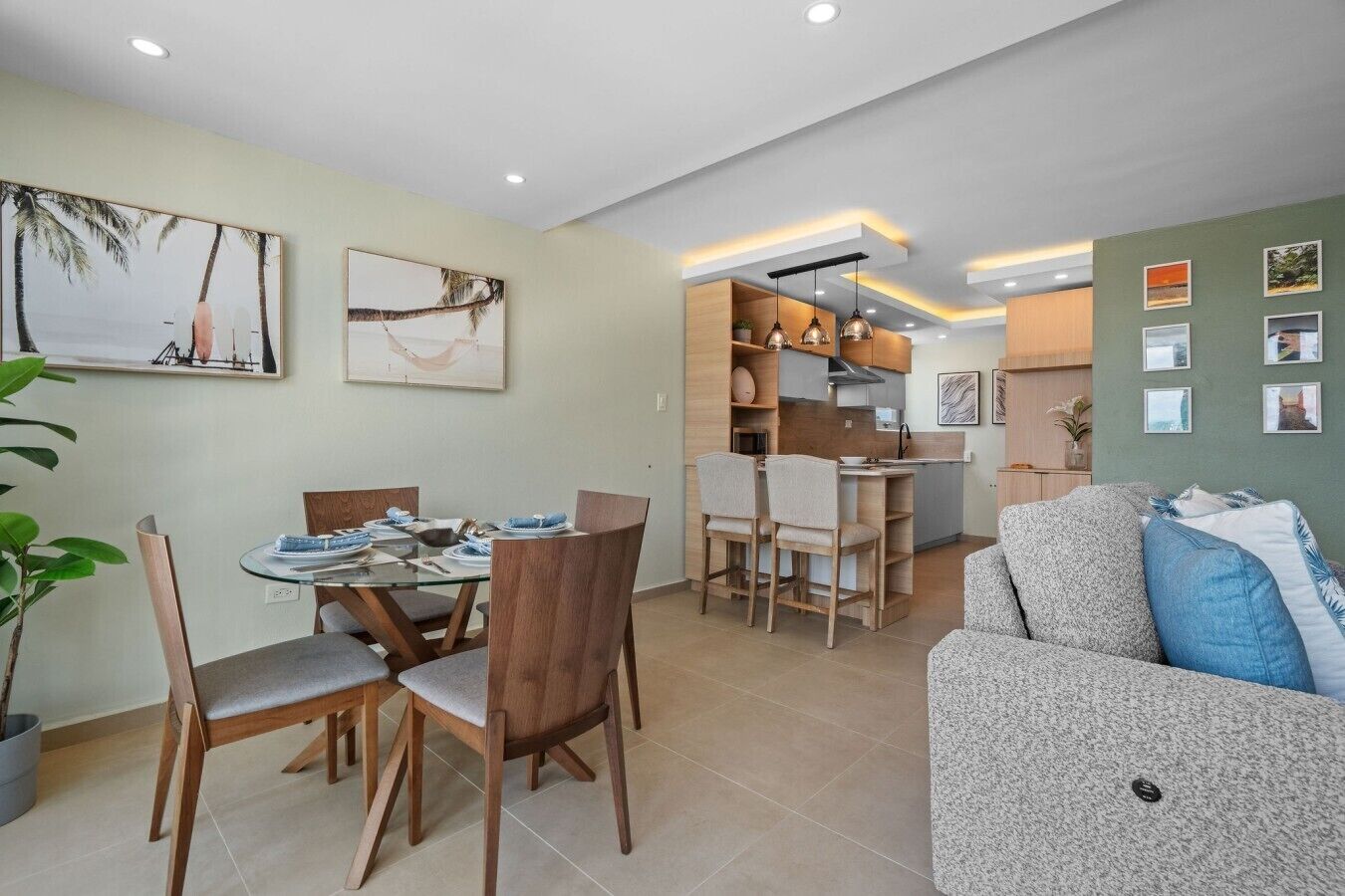 A modern living space with a dining area, kitchen, and seating area.