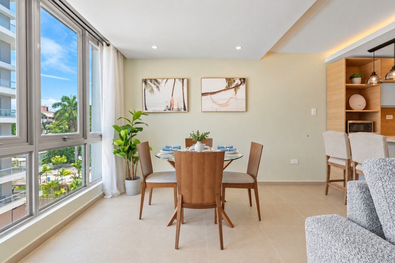 Bright and spacious open-concept living area with large windows, dining space, and modern lighting.