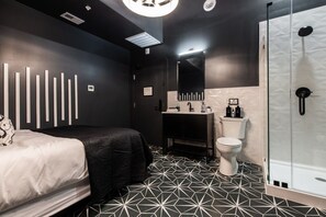 A modern bathroom with a shower, toilet, and sink. - Hollyhock Suite 309: 1 bed/1 bath (Louisville)