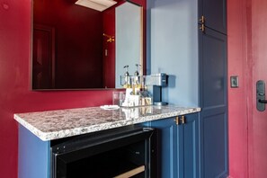 A kitchen with a granite countertop, a coffee machine, and a microwave. - Hollyhock Suite 308: 2 beds/1 bath (Louisville)