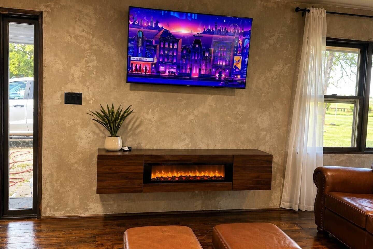 A living room with a fireplace, a television mounted on the wall, and a leather sofa.