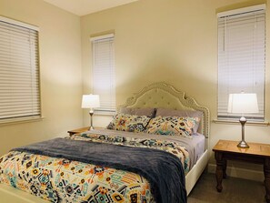 A bedroom with a bed, two bedside tables, and a window with blinds. - Brand new guest suite in beautiful locality (Mountain House)